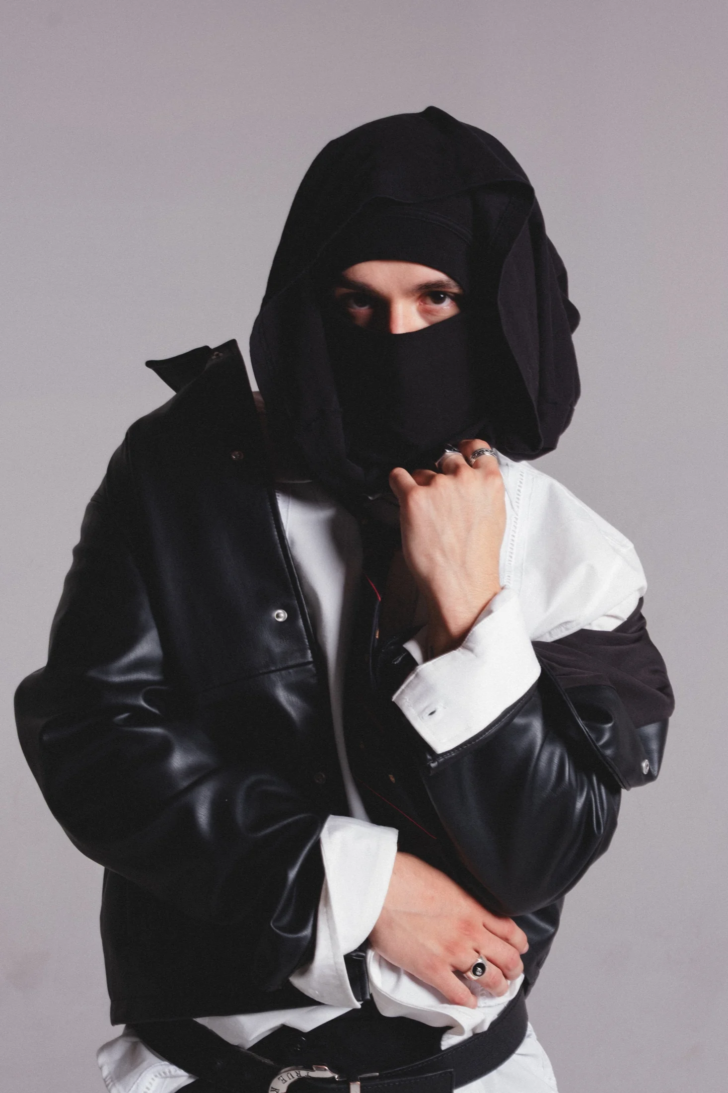 Santé in a layered black and white look with a wrapped face covering